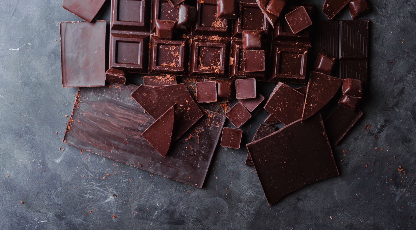 chocolate bar on table broken into pieces