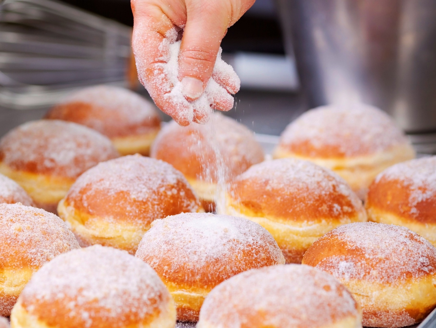 donuts being sprinkled with sugar